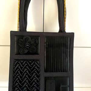 Cute black purse. 8x7.5. Can be worn as crossbody.